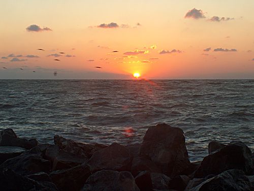 The sun slips behind the jetty